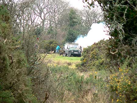 Distant view of Land Rover and bonfire smoke