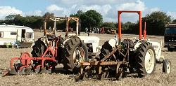 A pair of tractors with ploughs